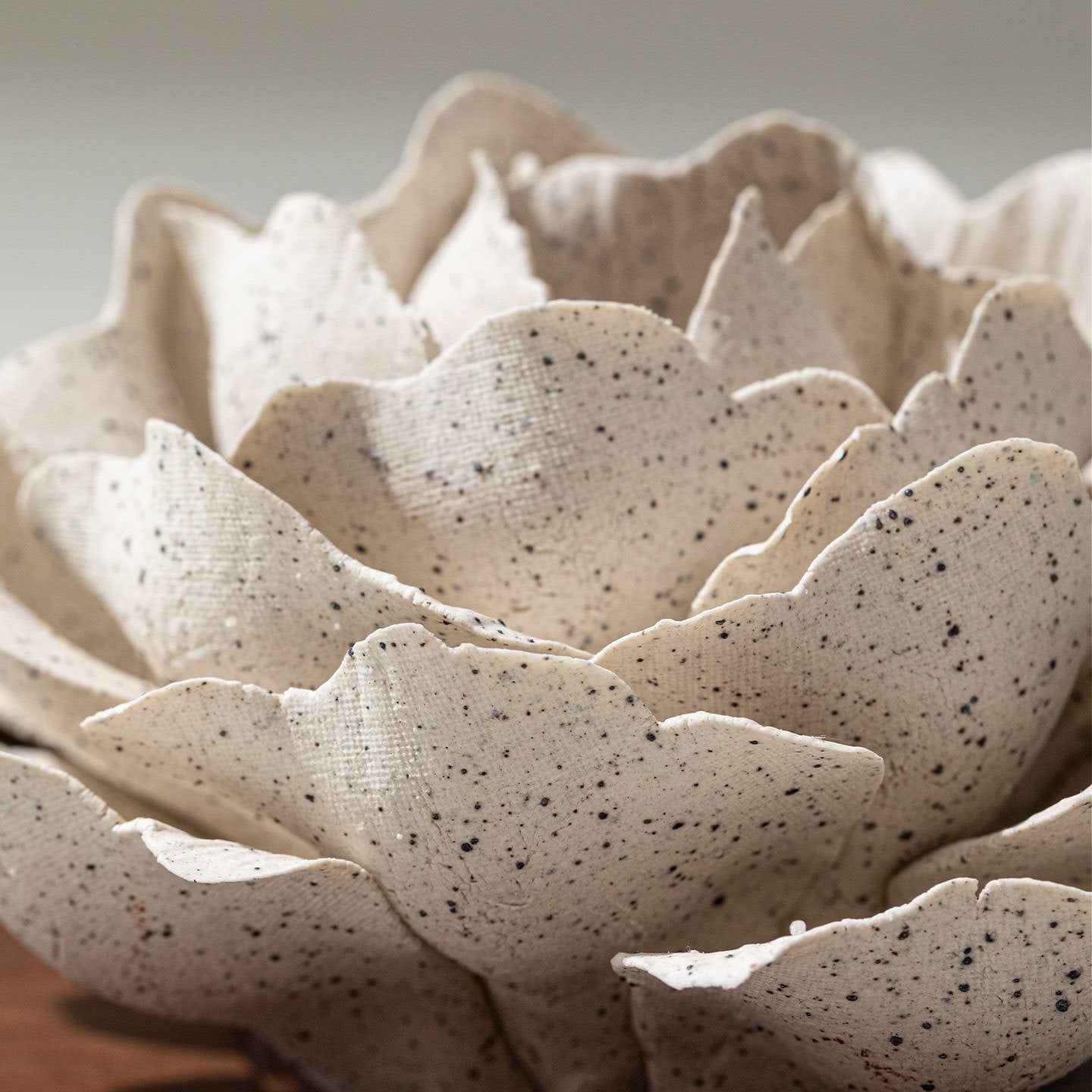 A close view of the texture and edges of a finished porcelain flower